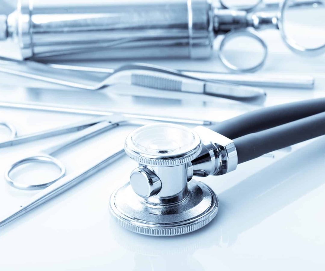 Image-focused-on-a-stethosocpe-with-other-medical-accessories-in-the-background.